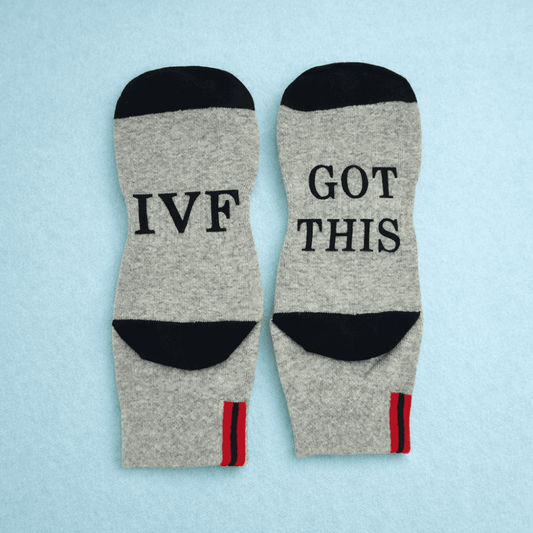 Gray socks with 'IVF Got This' text on a light blue background