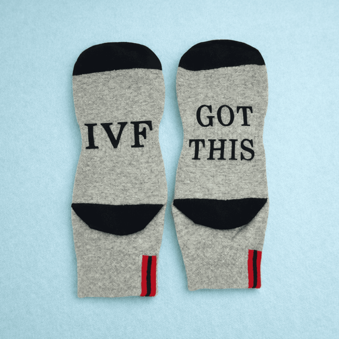 Gray socks with 'IVF Got This' text on a light blue background